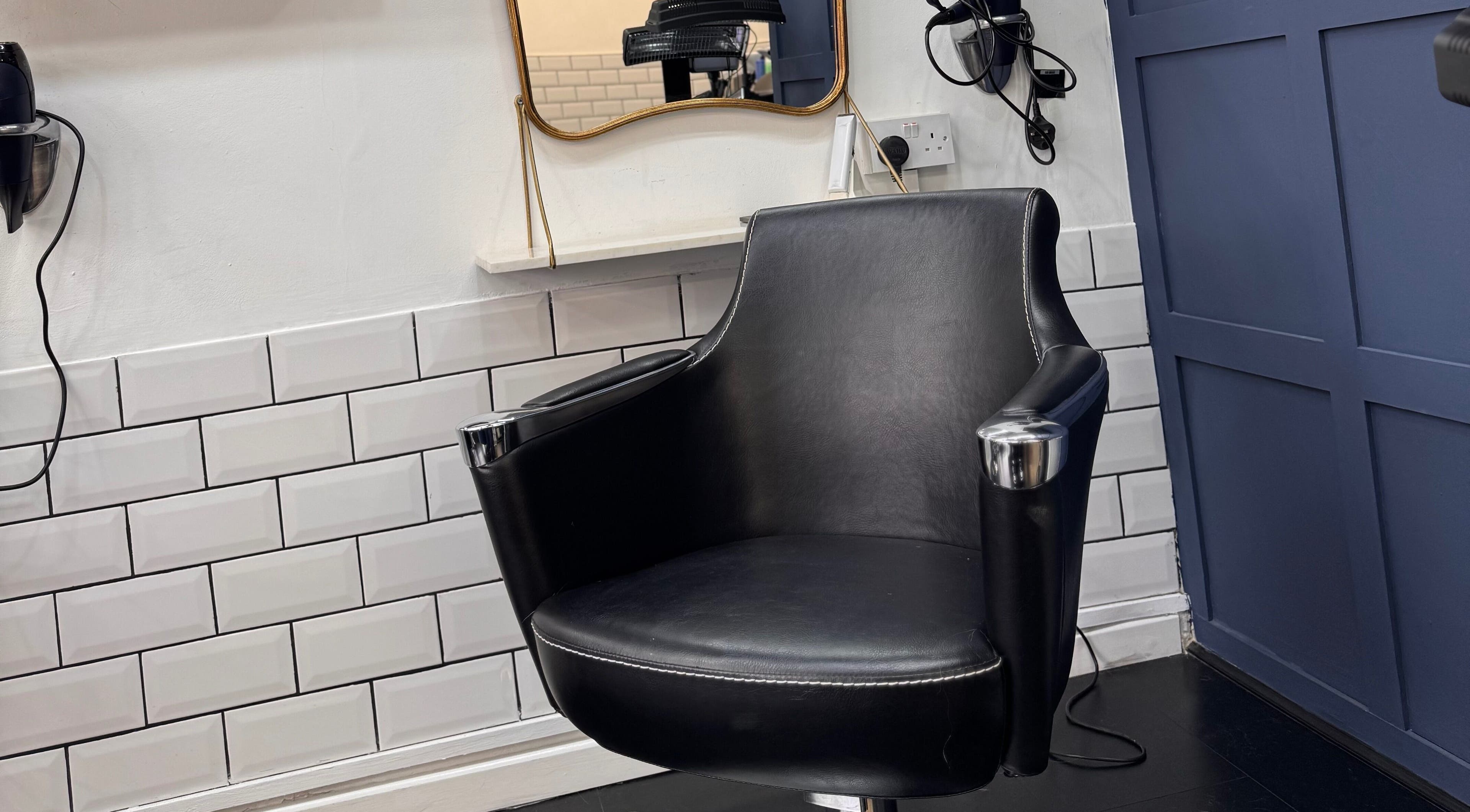 Sleek salon chair at David Brown Hairdressing and Aesthetics, Northampton, England, GB, enhancing client comfort.