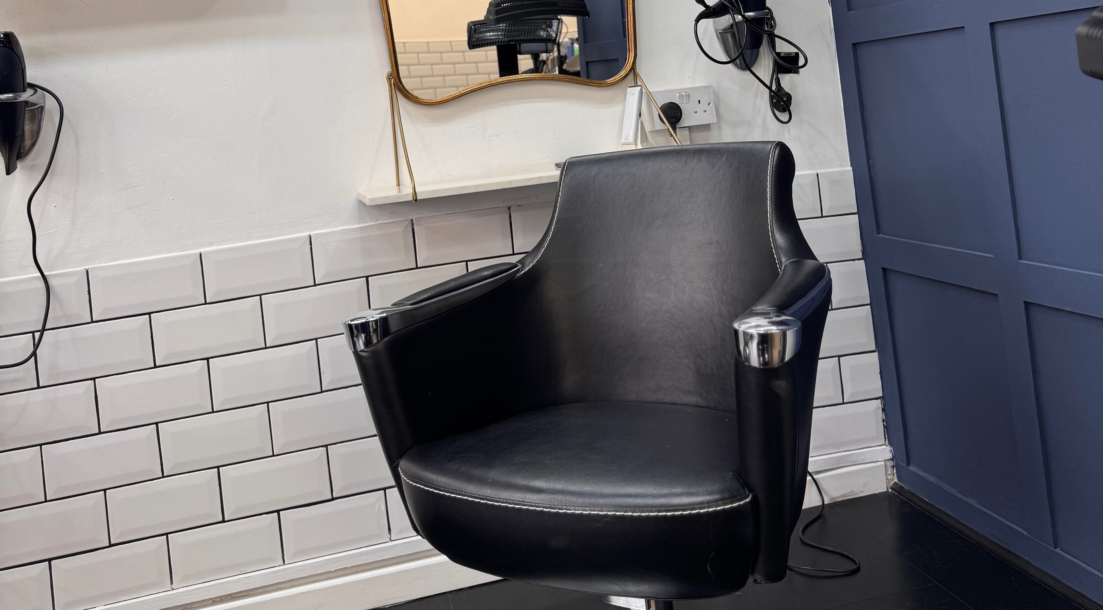 Sleek salon chair at David Brown Hairdressing and Aesthetics, Northampton, England, GB, enhancing client comfort.
