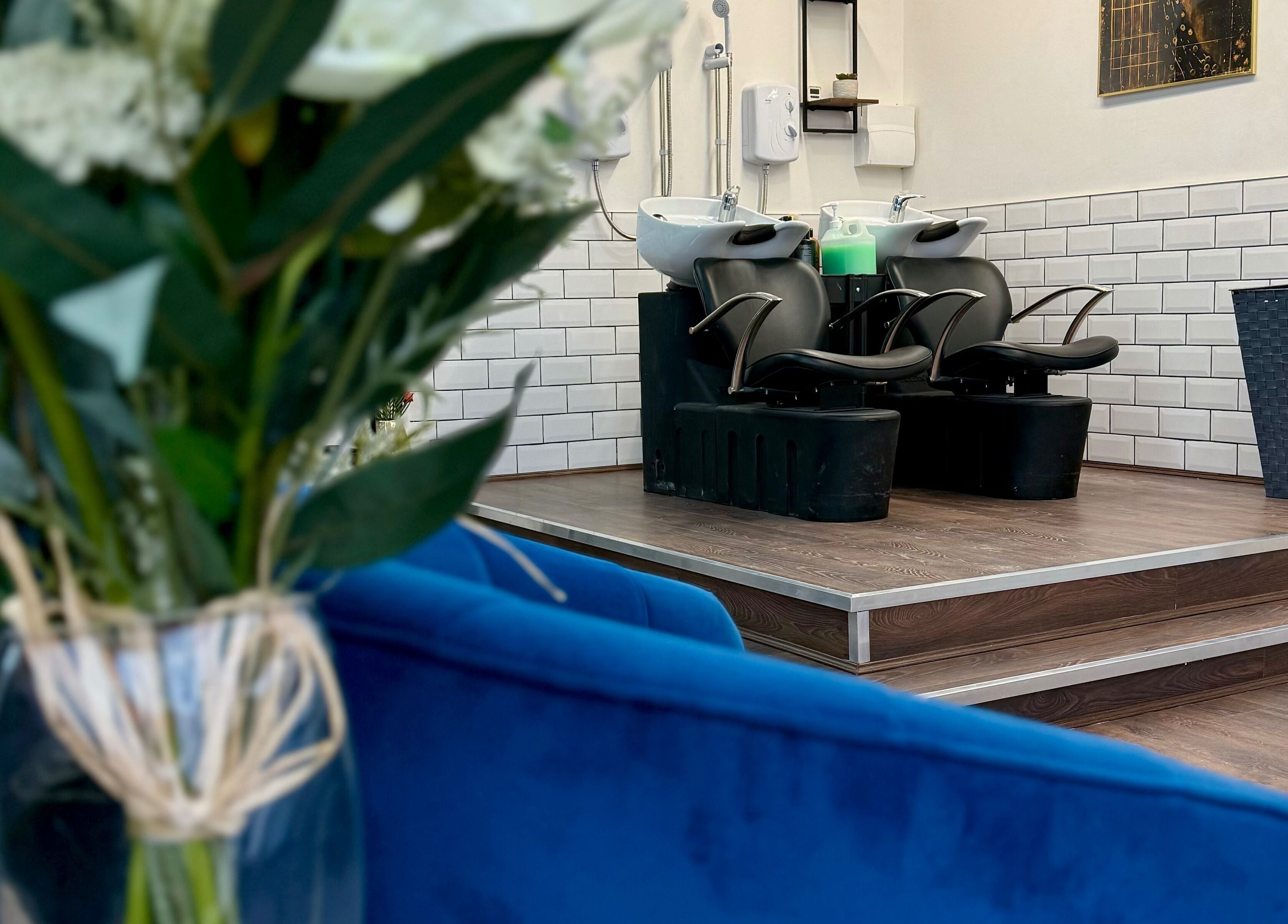 Stylish salon wash station at David Brown Hairdressing and Aesthetics, Northampton, England, GB with floral decor.