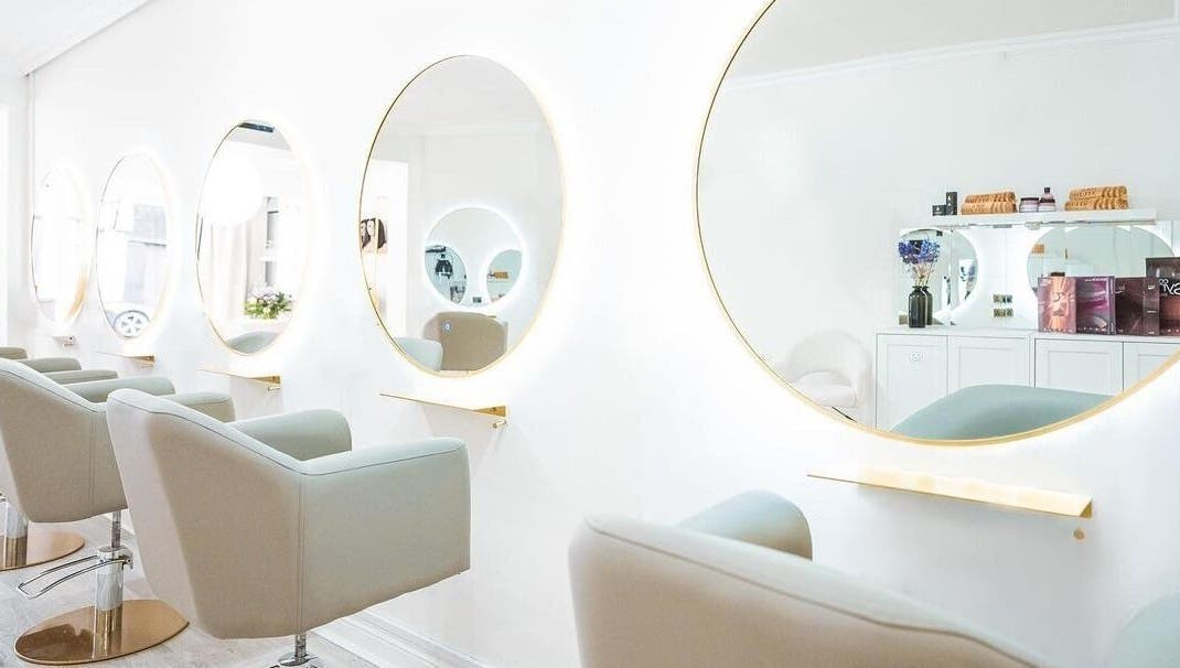 Elegant styling area with round mirrors at HBA Studio Dublin, Dublin, County Dublin, IE. Modern beauty setting.