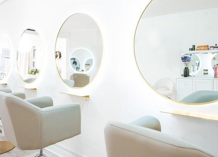 Elegant styling area with round mirrors at HBA Studio Dublin, Dublin, County Dublin, IE. Modern beauty setting.