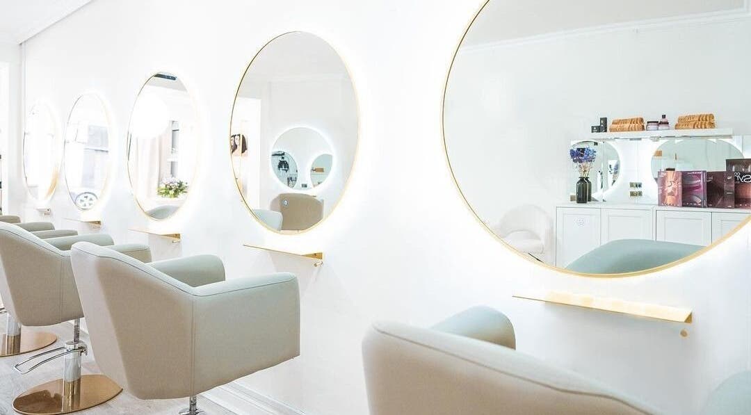 Elegant styling area with round mirrors at HBA Studio Dublin, Dublin, County Dublin, IE. Modern beauty setting.