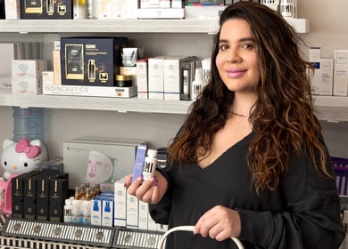 Woman at The Brow Shaping Queen in Frisco, Texas, US with a variety of beauty products.