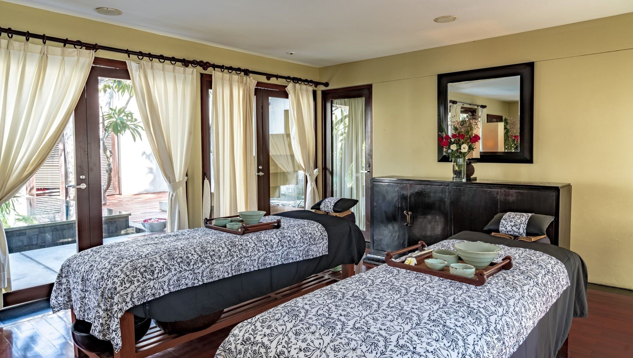 Tranquil double treatment room at Kayumanis Spa Nusa Dua, Bali, Bali, ID with elegant decor and soft lighting.