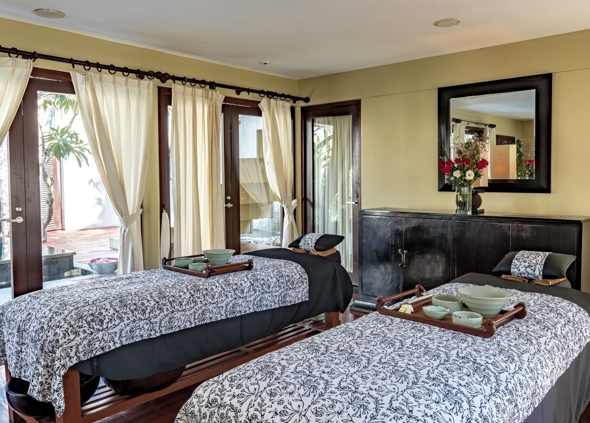 Tranquil double treatment room at Kayumanis Spa Nusa Dua, Bali, Bali, ID with elegant decor and soft lighting.