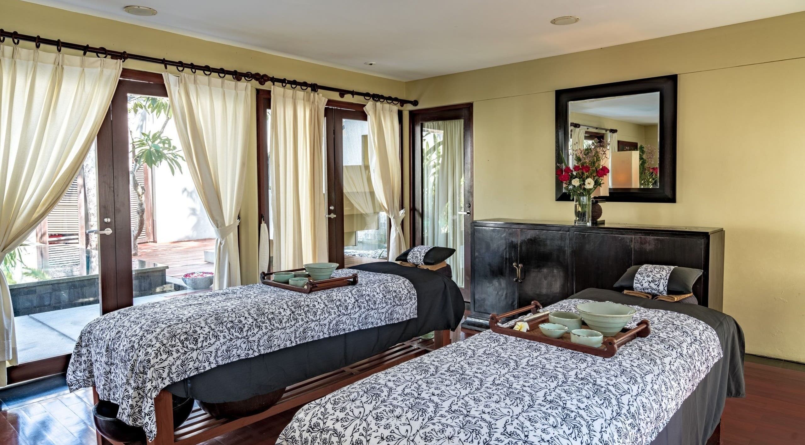 Tranquil double treatment room at Kayumanis Spa Nusa Dua, Bali, Bali, ID with elegant decor and soft lighting.