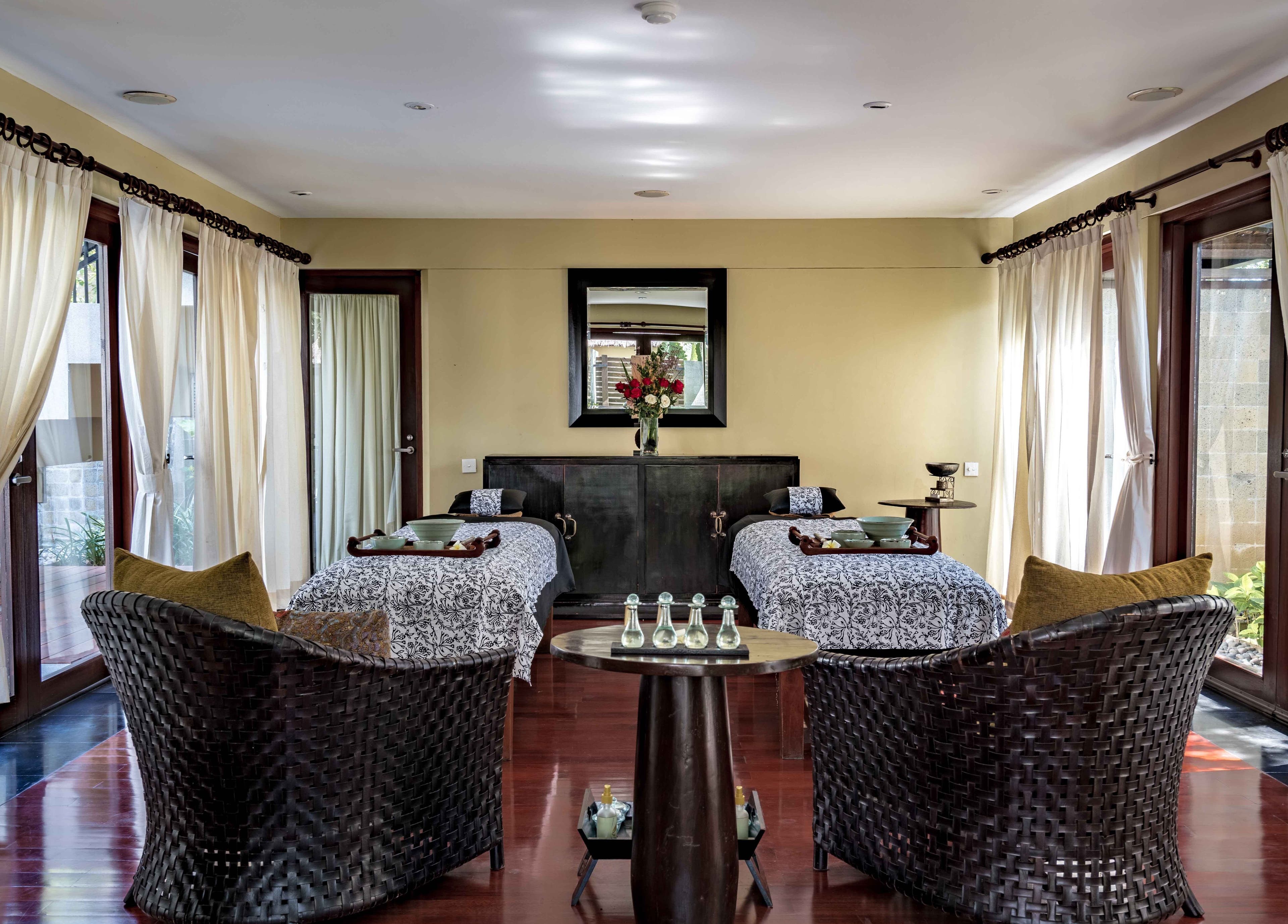 Relaxing treatment room with twin beds at Kayumanis Spa Nusa Dua, Bali, Bali, ID, featuring elegant decor.