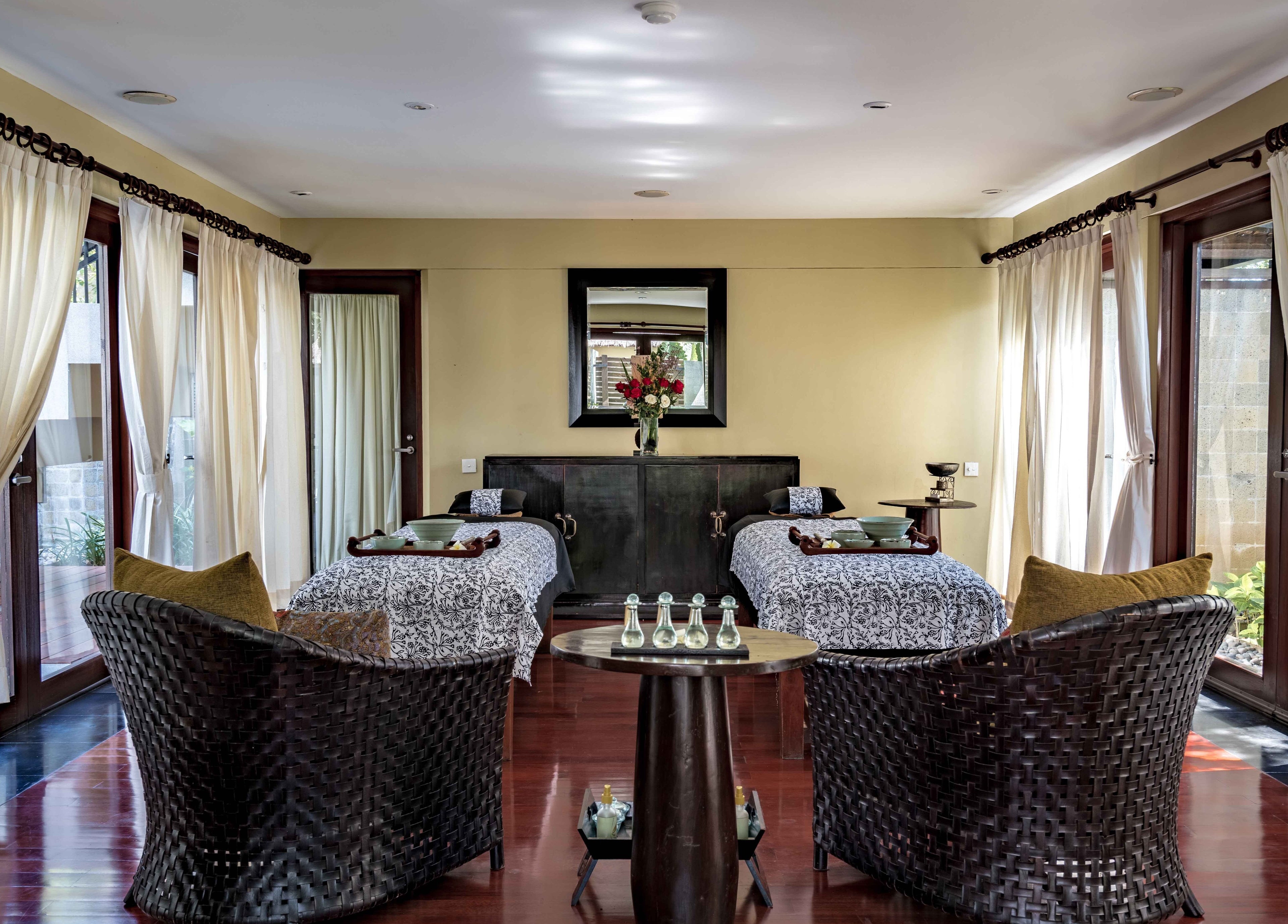 Relaxing treatment room with twin beds at Kayumanis Spa Nusa Dua, Bali, Bali, ID, featuring elegant decor.
