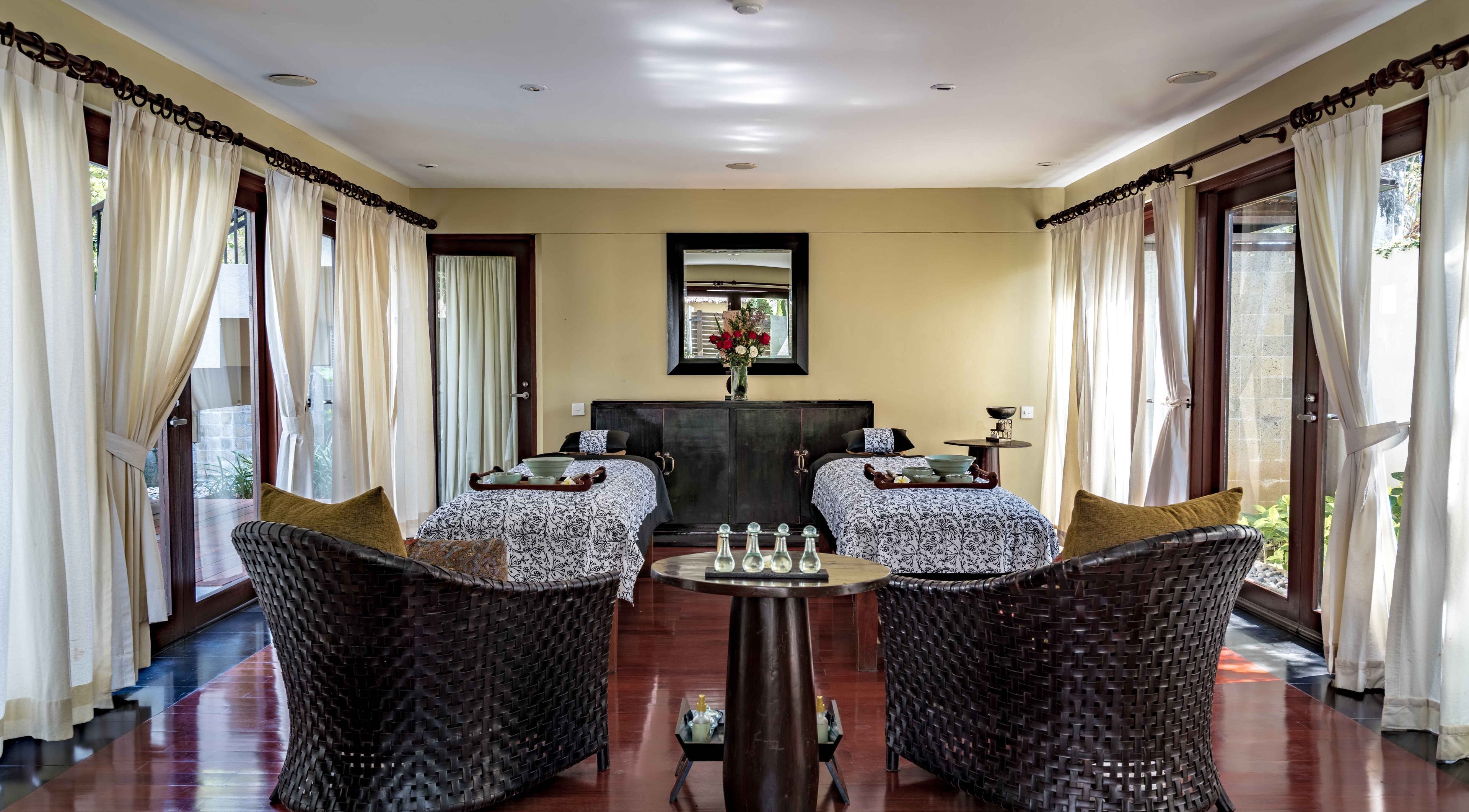 Relaxing treatment room with twin beds at Kayumanis Spa Nusa Dua, Bali, Bali, ID, featuring elegant decor.
