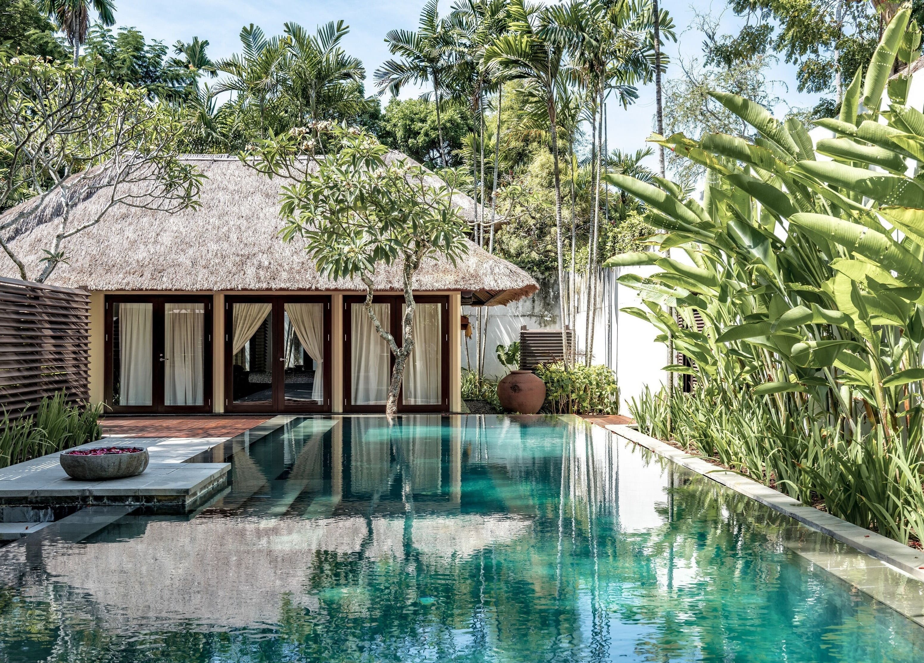 Serene poolside view at Kayumanis Spa Nusa Dua, Bali. Tranquil retreat in lush greenery, Bali, Bali, ID.