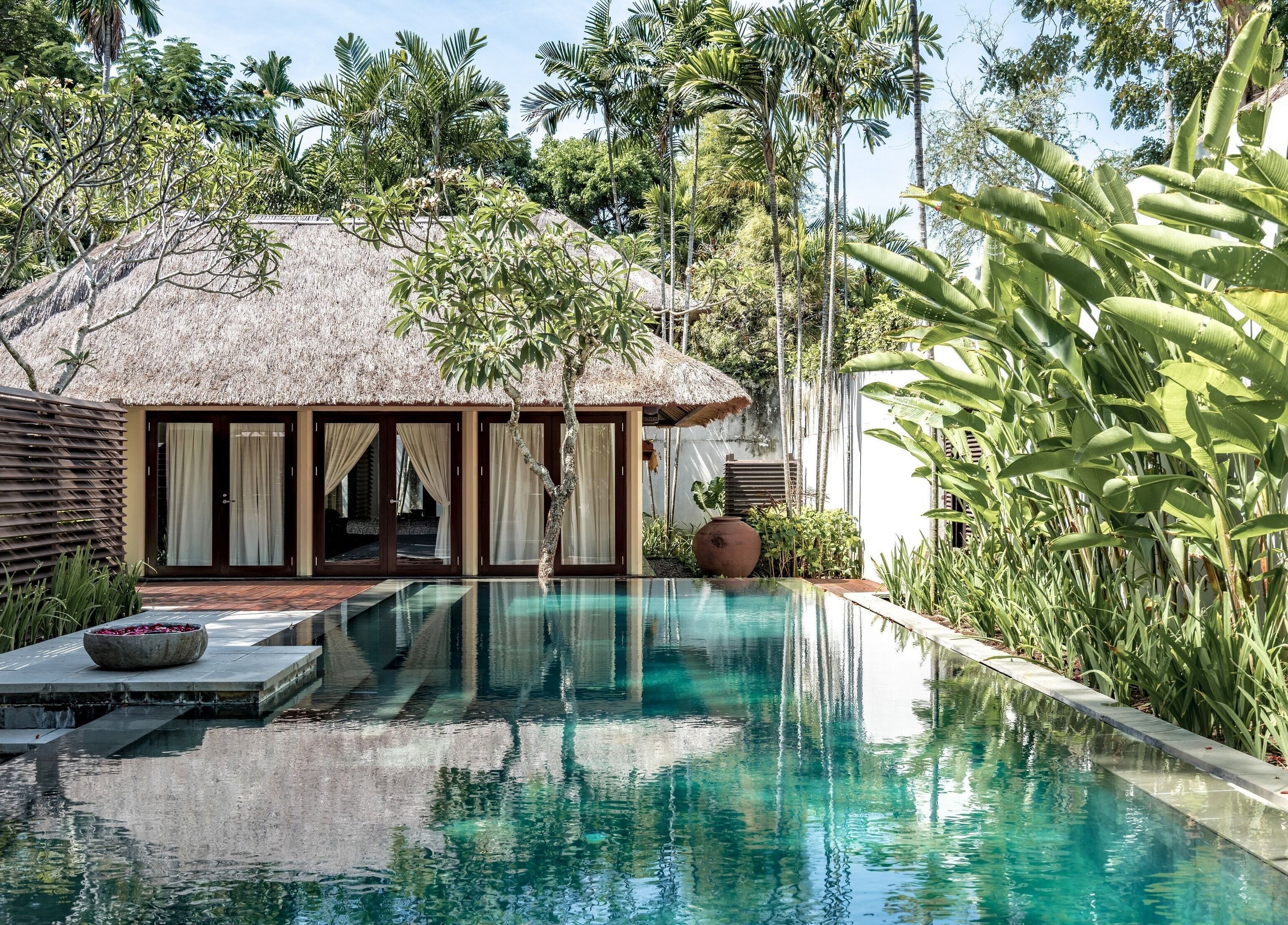 Serene poolside view at Kayumanis Spa Nusa Dua, Bali. Tranquil retreat in lush greenery, Bali, Bali, ID.
