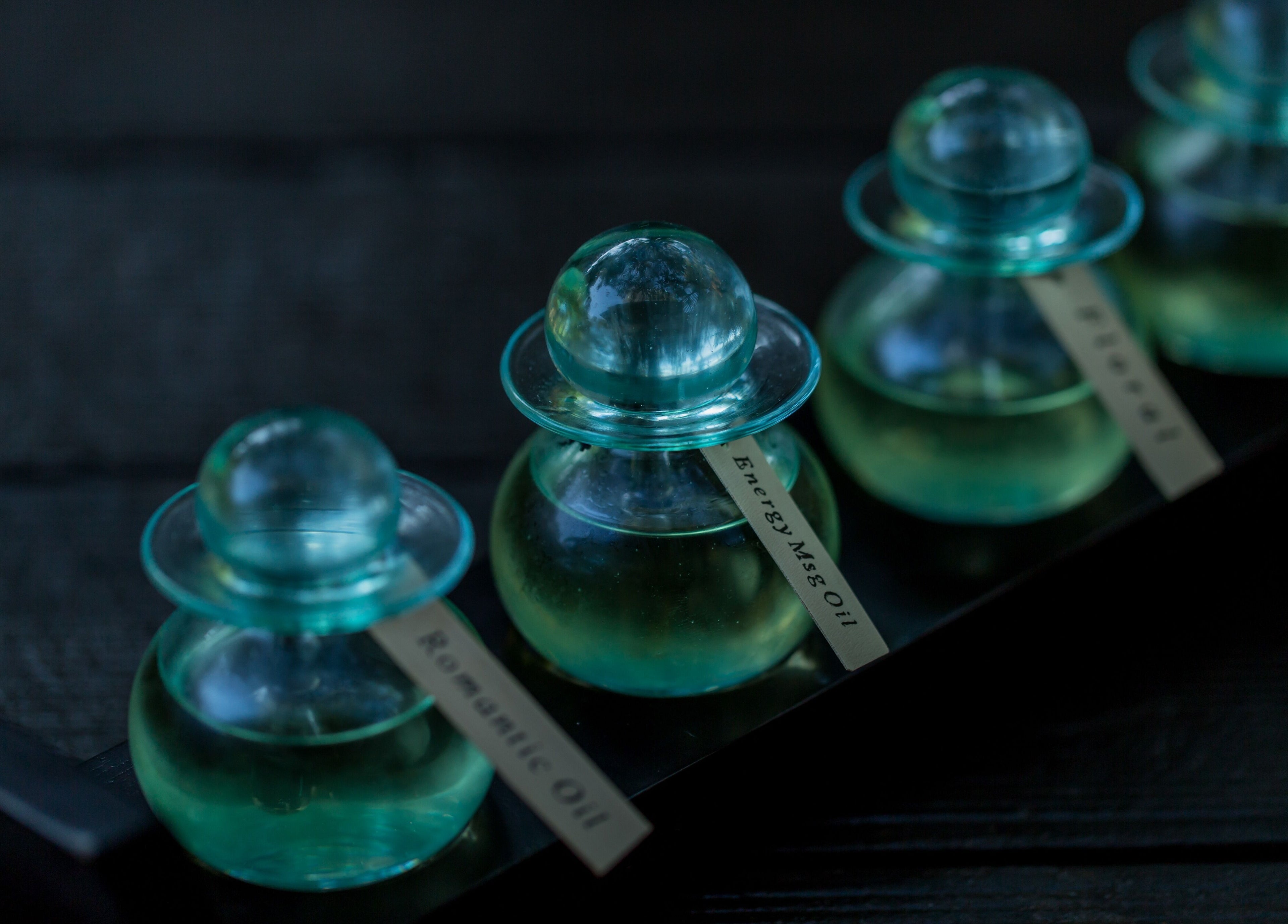 Aromatic oils in glass bottles at Kayumanis Spa Nusa Dua, Bali, Bali, ID, emphasizing relaxation and luxury.