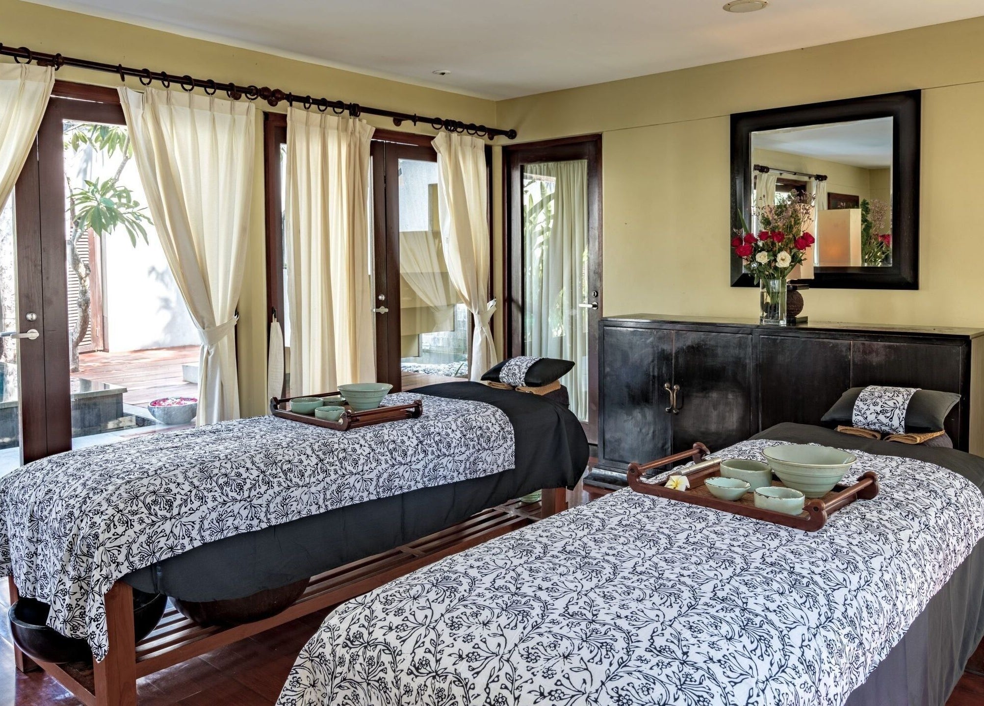 Relaxing spa treatment room at Kayumanis Spa Ubud, Bali, Bali, ID with twin massage beds.