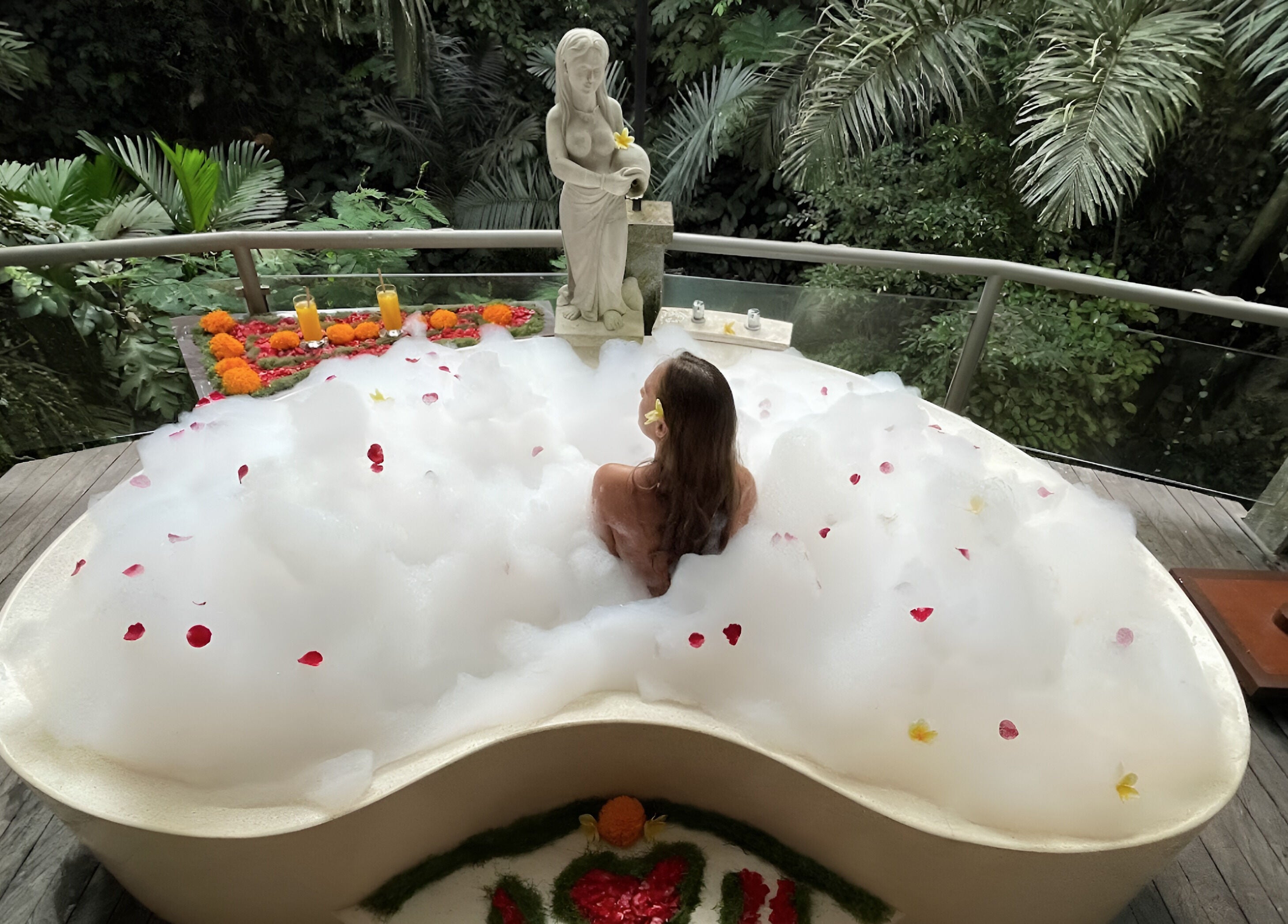Relaxing bubble bath at Kayumanis Spa Ubud, Bali. Surrounded by lush greenery for tranquility.