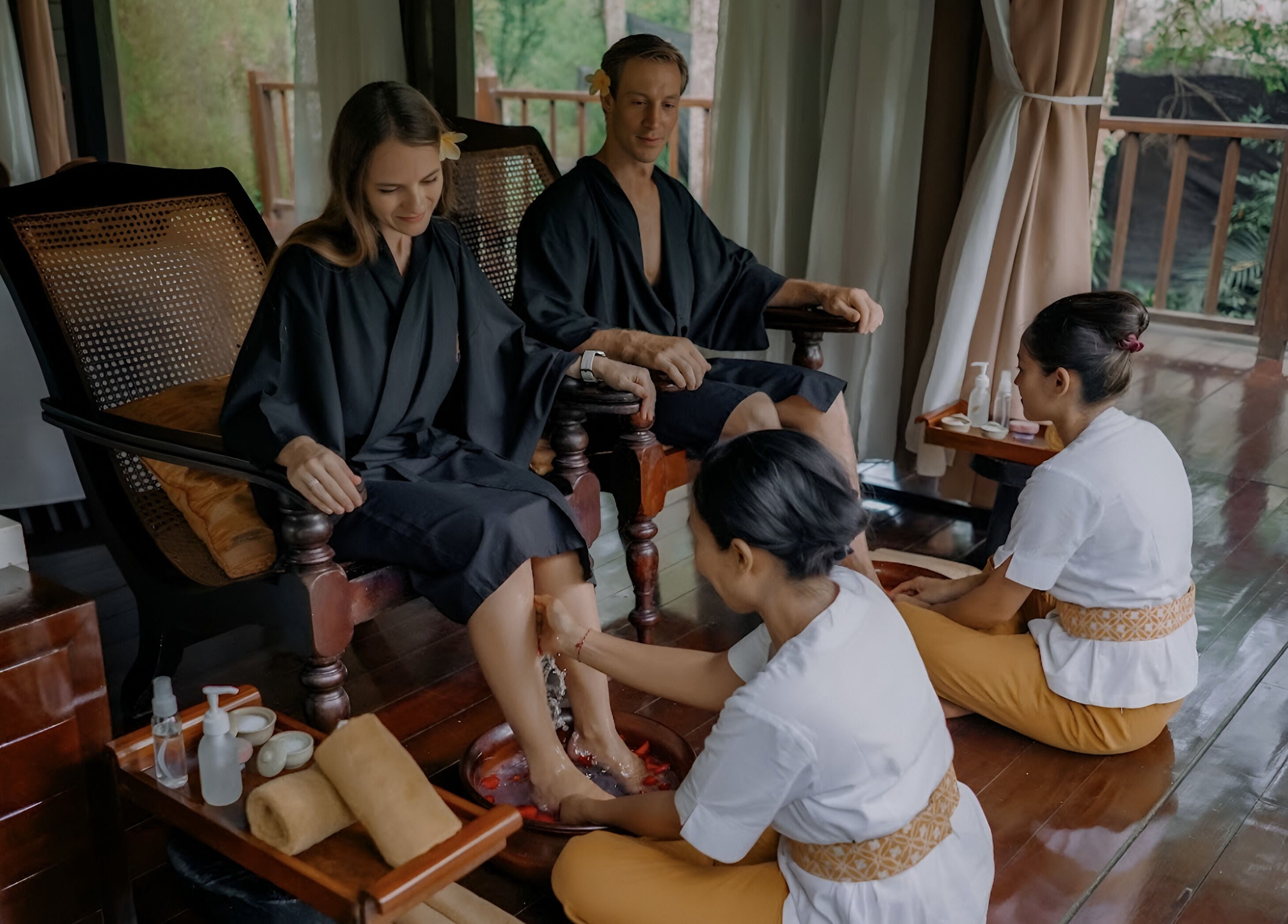 Couples enjoying foot baths at Kayumanis Spa Ubud in Bali, Bali, ID.