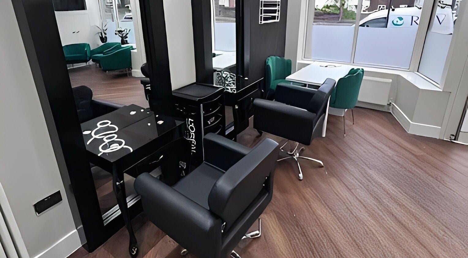 Modern salon chairs and mirrors at Lysa Harvey Hair and Beauty, Bebington, England, GB.