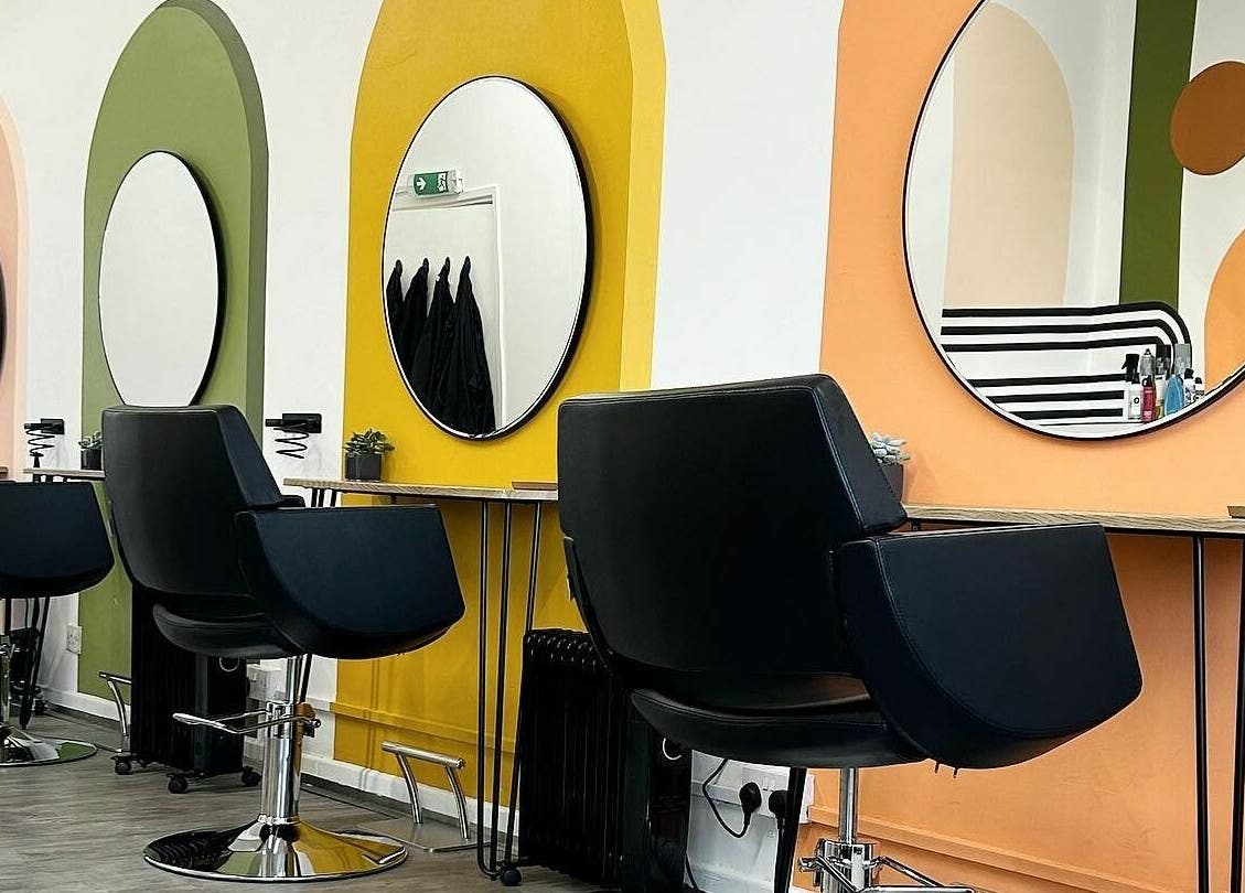 Stylish salon interior at That Nail Studio, Handforth, England, GB, featuring vibrant mirror stations and chairs.