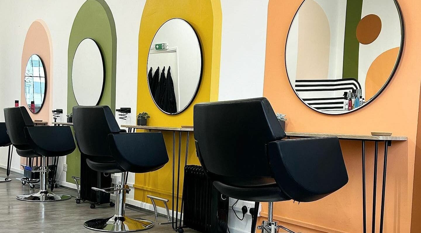Stylish salon interior at That Nail Studio, Handforth, England, GB, featuring vibrant mirror stations and chairs.