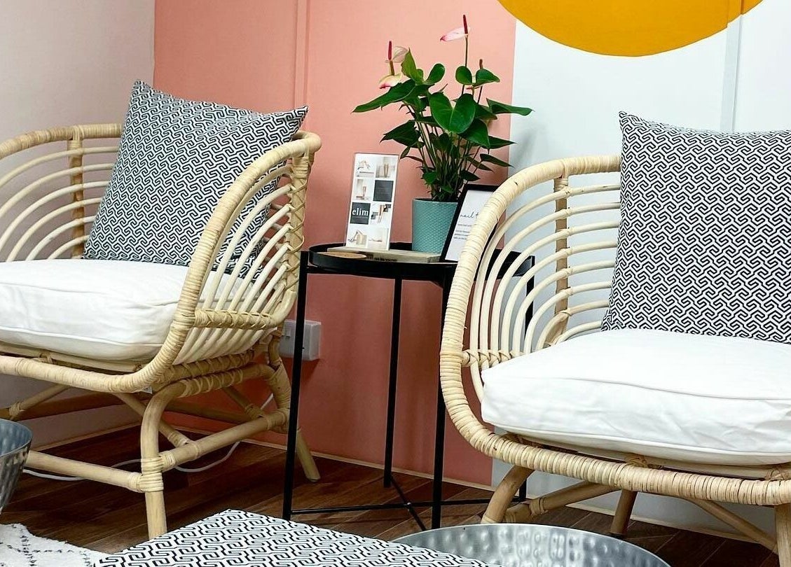 Inviting seating area at That Nail Studio, Handforth, England, GB with stylish decor and rattan chairs.