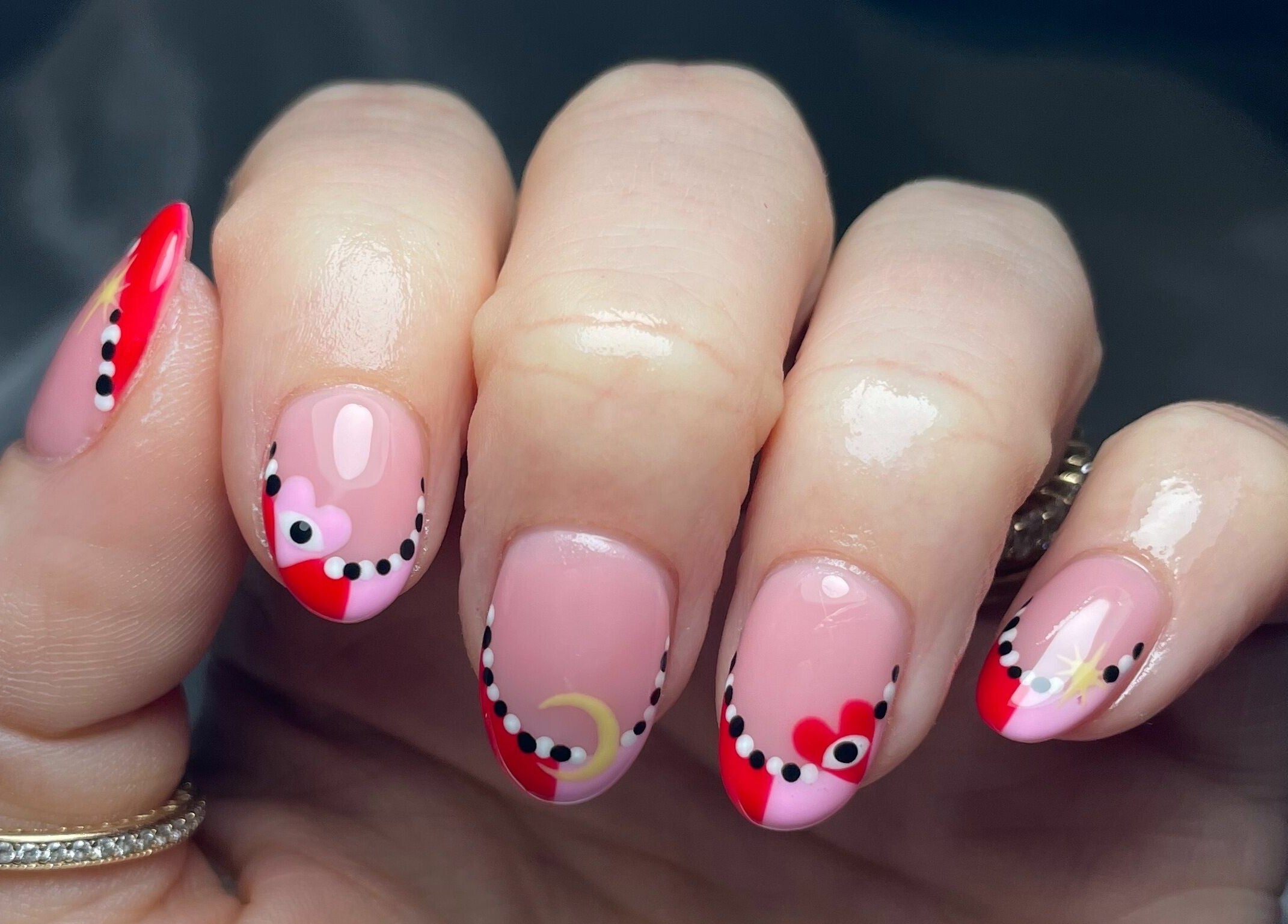 Elegant nail art with red and pink designs at That Nail Studio, Handforth, England, GB.