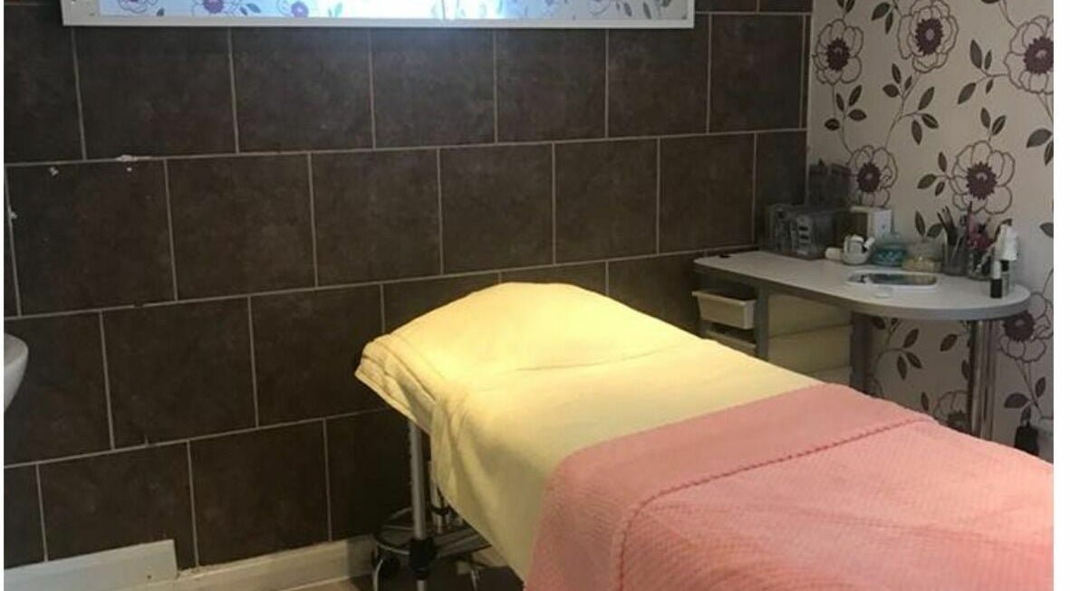 Cozy treatment room at Broadway Beauty, Southend-on-Sea, England, GB featuring a massage table and floral decor.