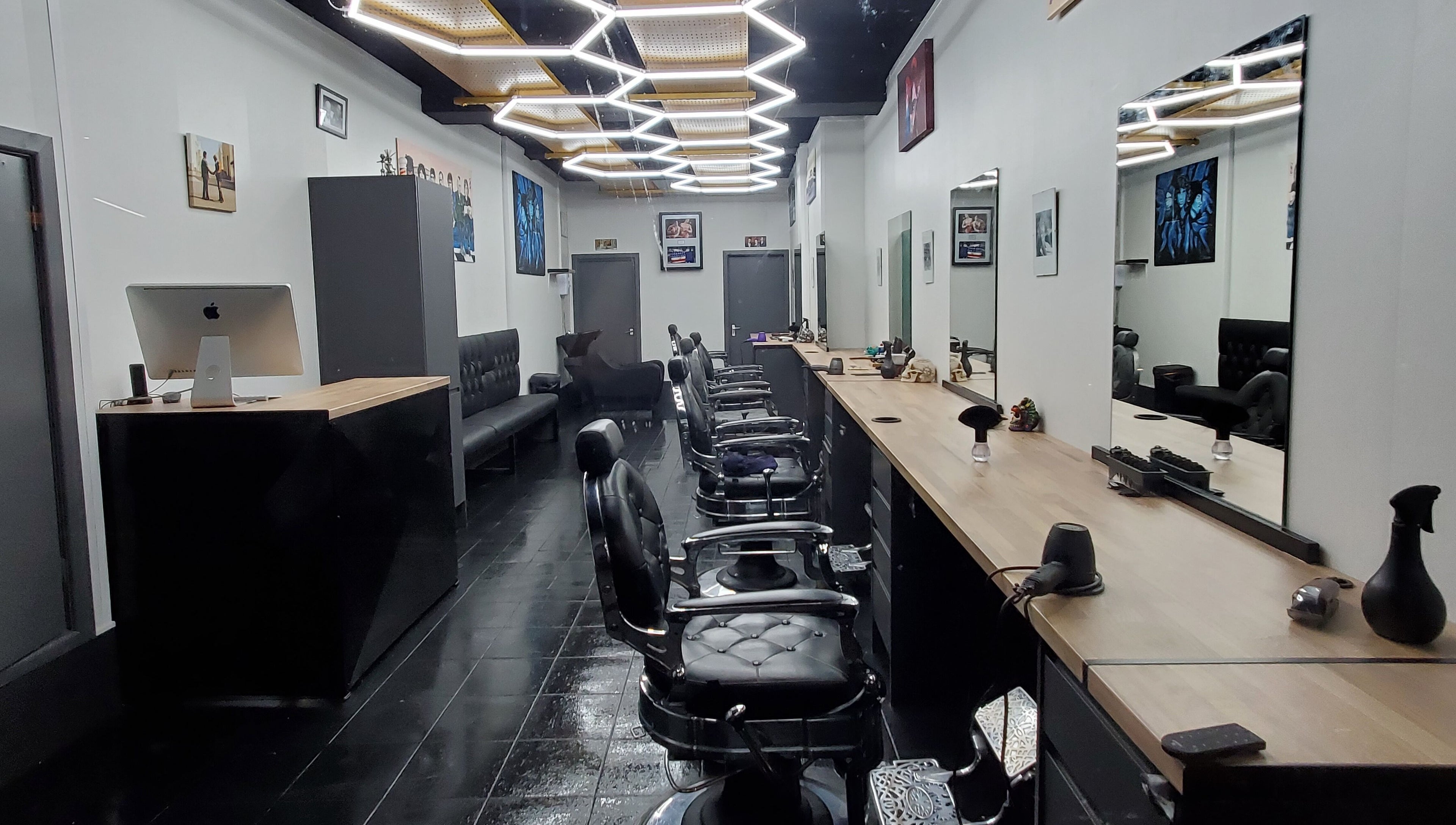 Chic interior of Sauchiehall Barbers in Glasgow, Scotland, GB featuring sleek black chairs and stylish decor.