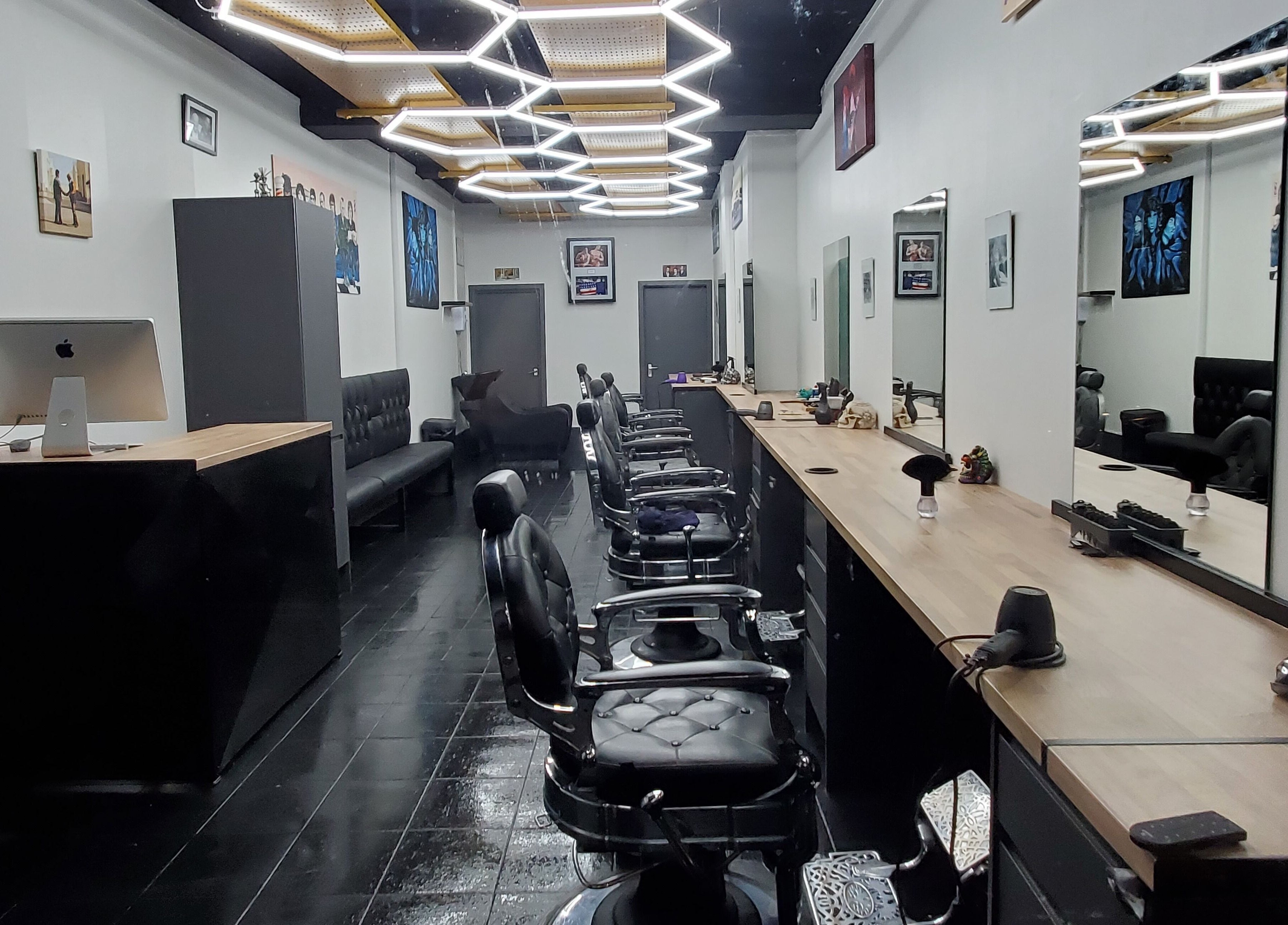 Chic interior of Sauchiehall Barbers in Glasgow, Scotland, GB featuring sleek black chairs and stylish decor.