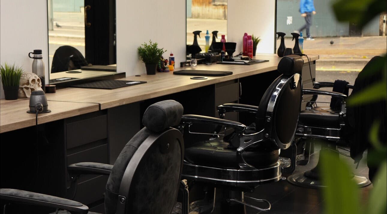 Modern barber chairs at Sauchiehall Barbers, Glasgow, Scotland, GB, offering a stylish haircut experience.