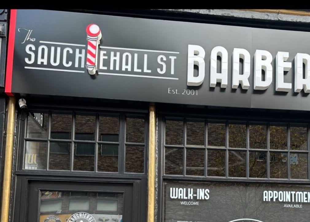 Sauchiehall Barbers storefront sign in Glasgow, Scotland, GB, welcoming walk-ins and appointments.