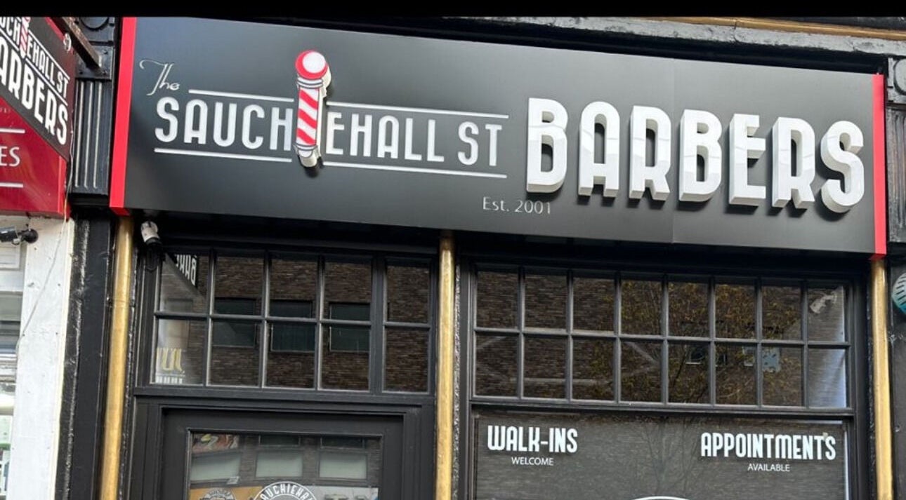 Sauchiehall Barbers storefront sign in Glasgow, Scotland, GB, welcoming walk-ins and appointments.