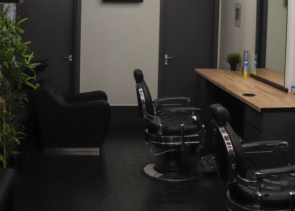 Modern barber chairs and sleek decor at Sauchiehall Barbers, Glasgow, Scotland, GB.