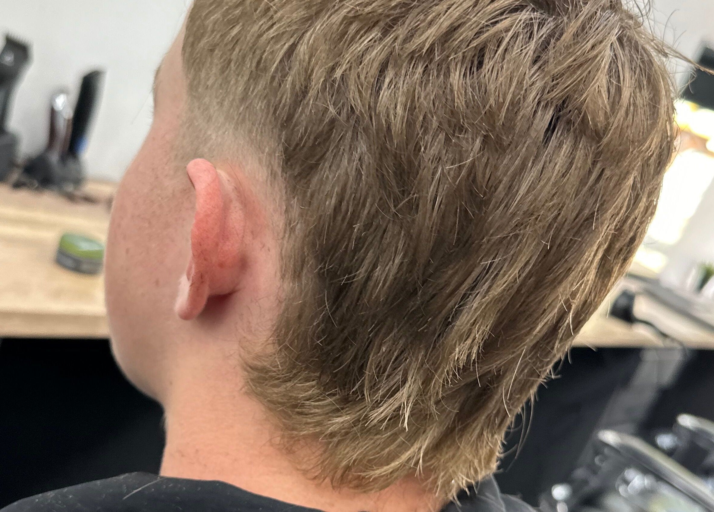 Close-up of a stylish mullet haircut at Sauchiehall Barbers in Glasgow, Scotland, GB.
