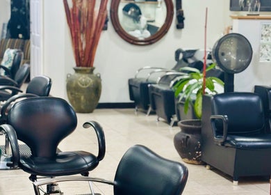 Interior of Arelis Beauty Salon featuring chic black seating in Orlando, Florida, US.