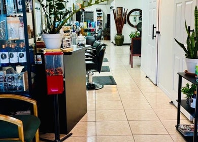 Spacious interior of Arelis Beauty Salon in Orlando, Florida, US showcasing sleek chairs and vibrant plants.