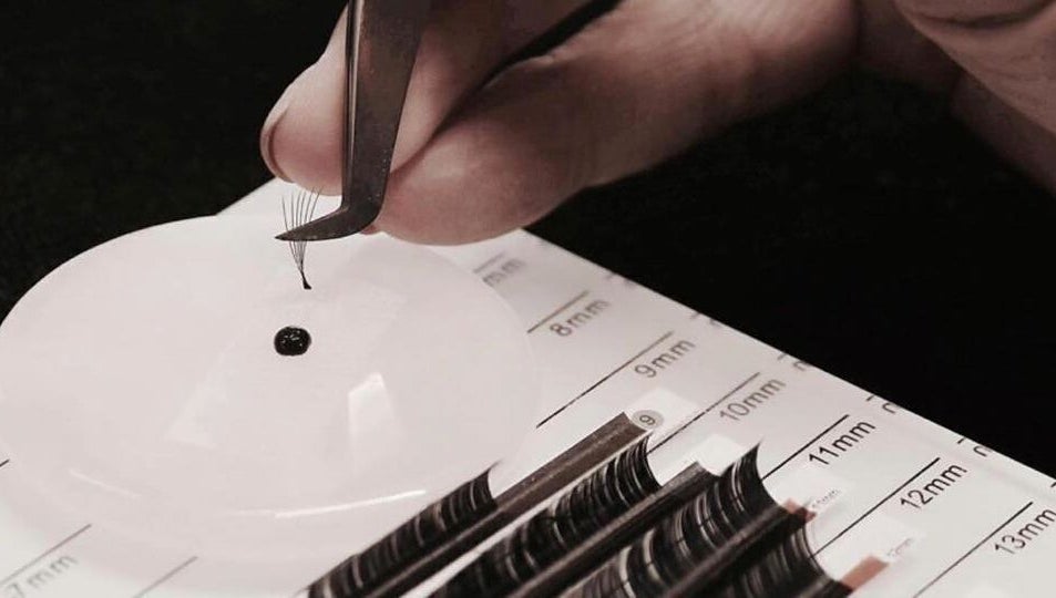 Close-up of lash extensions at Laura at Elite Beauty, Peterborough, England, GB. Tweezers and lash grid visible.