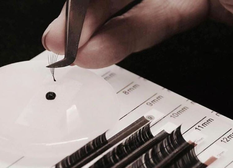 Close-up of lash extensions at Laura at Elite Beauty, Peterborough, England, GB. Tweezers and lash grid visible.