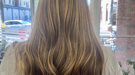 Beautiful wavy hair styled at Salon Femia in Somerville, Massachusetts, US, reflecting natural golden highlights.