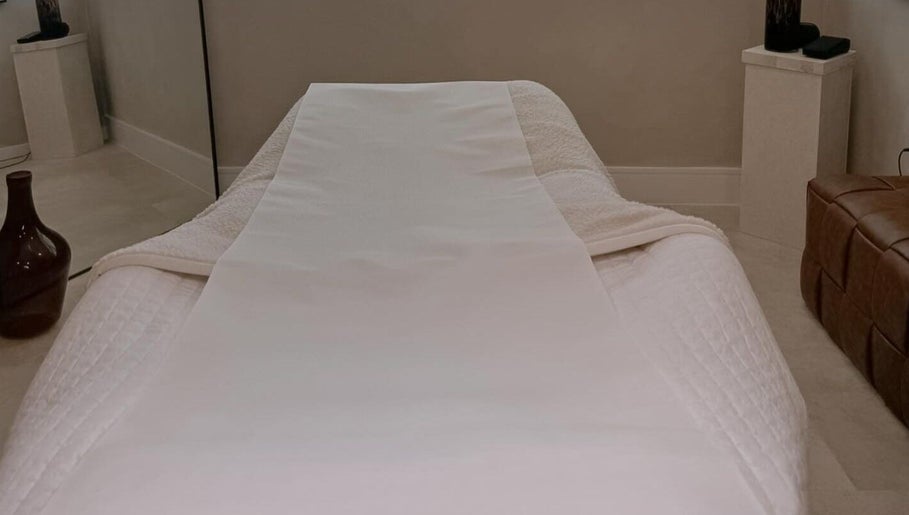 Relaxing treatment bed at The Glow Clinic, Cardiff Bay, GB, offering premium beauty and wellness services.