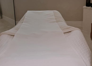 Relaxing treatment bed at The Glow Clinic, Cardiff Bay, GB, offering premium beauty and wellness services.