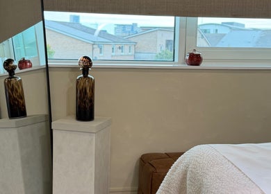 Relaxing treatment room at The Glow Clinic, Cardiff Bay, GB, with elegant decor and soothing ambiance.