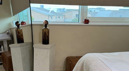 Relaxing treatment room at The Glow Clinic, Cardiff Bay, GB, with elegant decor and soothing ambiance.