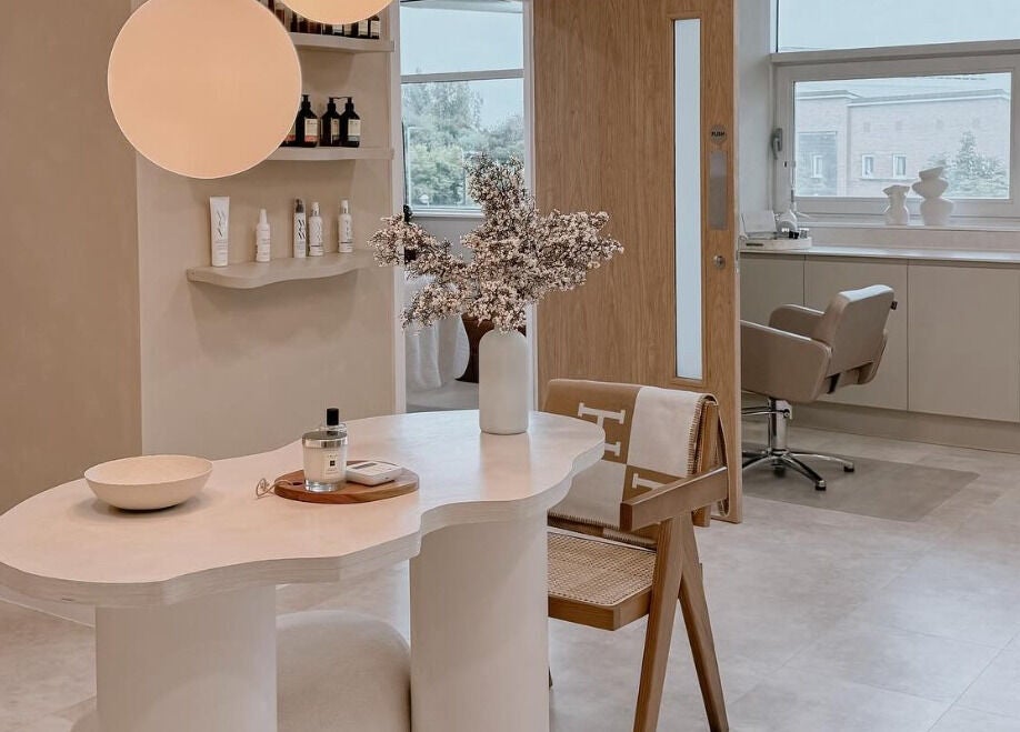 Elegant interior of The Glow Clinic in Cardiff Bay, GB showcasing a stylish treatment area.