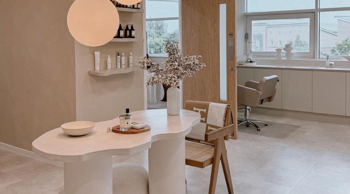 Elegant interior of The Glow Clinic in Cardiff Bay, GB showcasing a stylish treatment area.