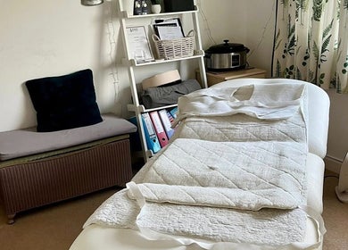Cozy massage room at Gower Garden Therapies, Southgate, Wales, GB with a treatment bed and elegant decor.