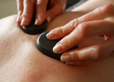 Relaxing hot stone massage at Gower Garden Therapies in Southgate, Wales, GB.