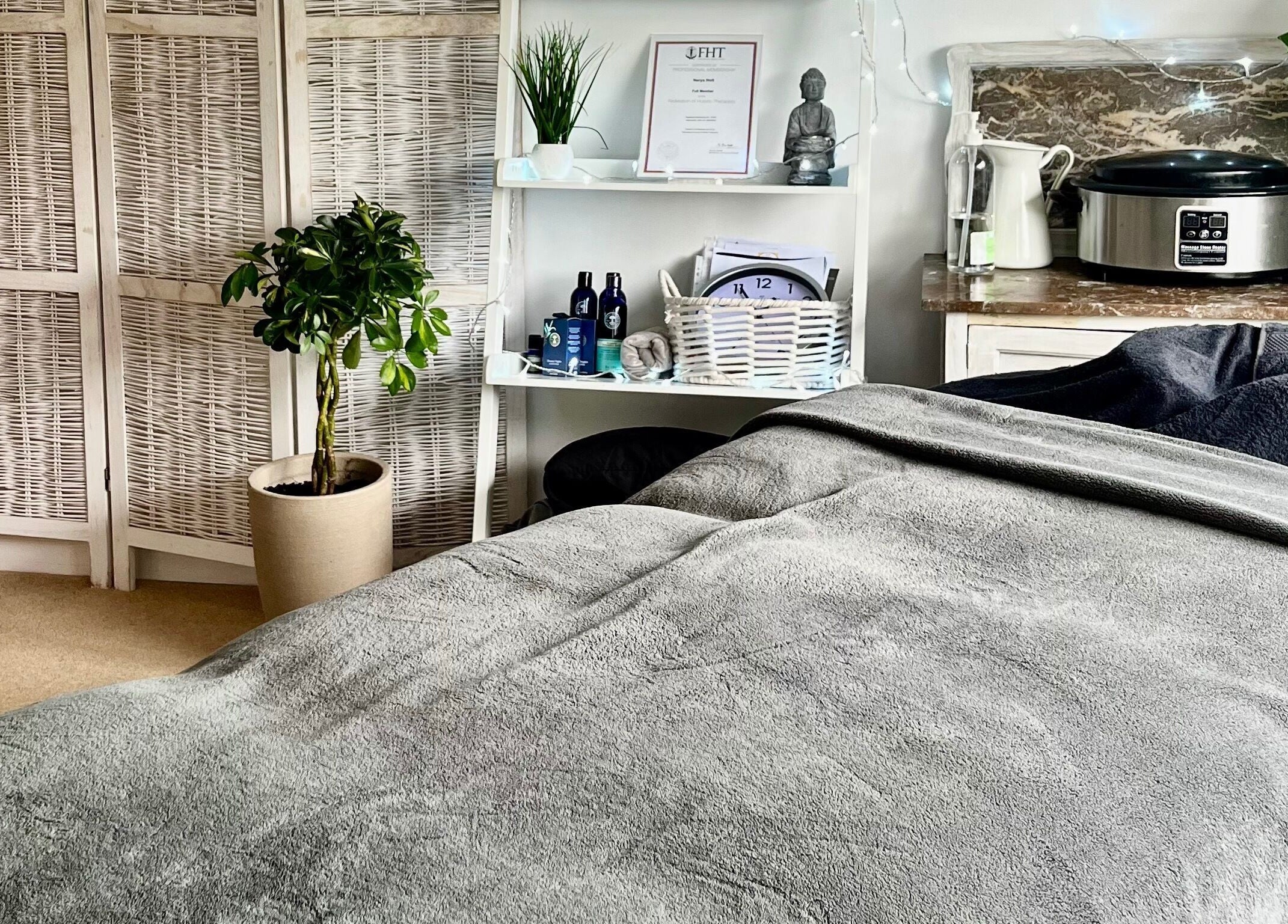A serene therapy room at Gower Garden Therapies, Southgate, Wales, GB with a cozy massage table and calming decor.