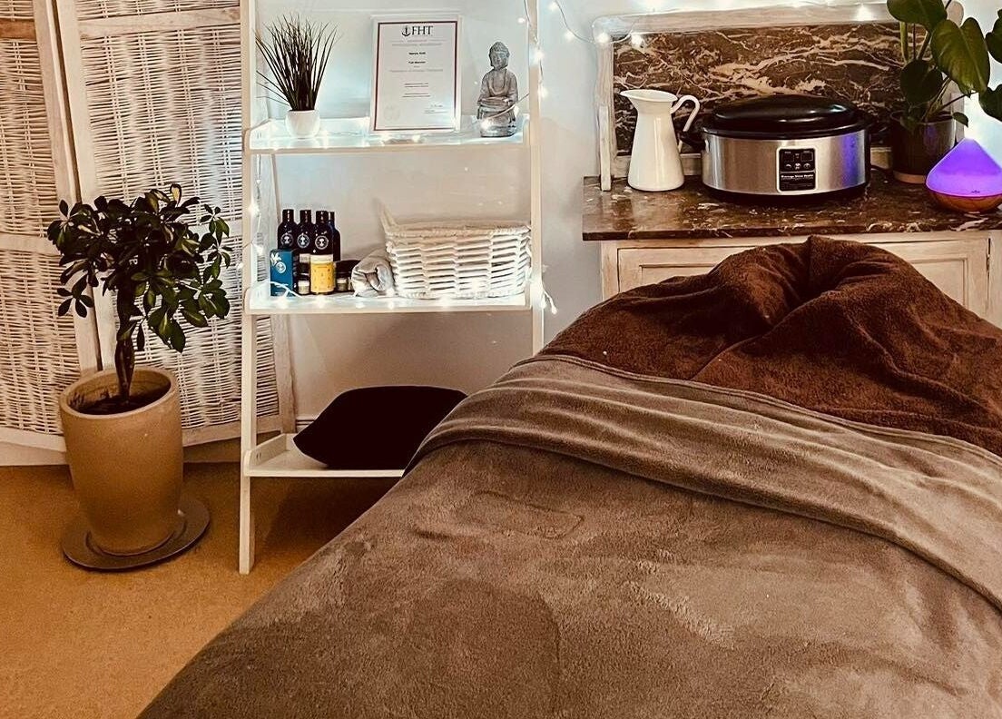 Cozy therapy room at Gower Garden Therapies, Southgate, Wales, GB with soft lighting and warm décor.