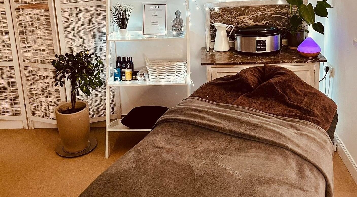 Cozy therapy room at Gower Garden Therapies, Southgate, Wales, GB with soft lighting and warm décor.
