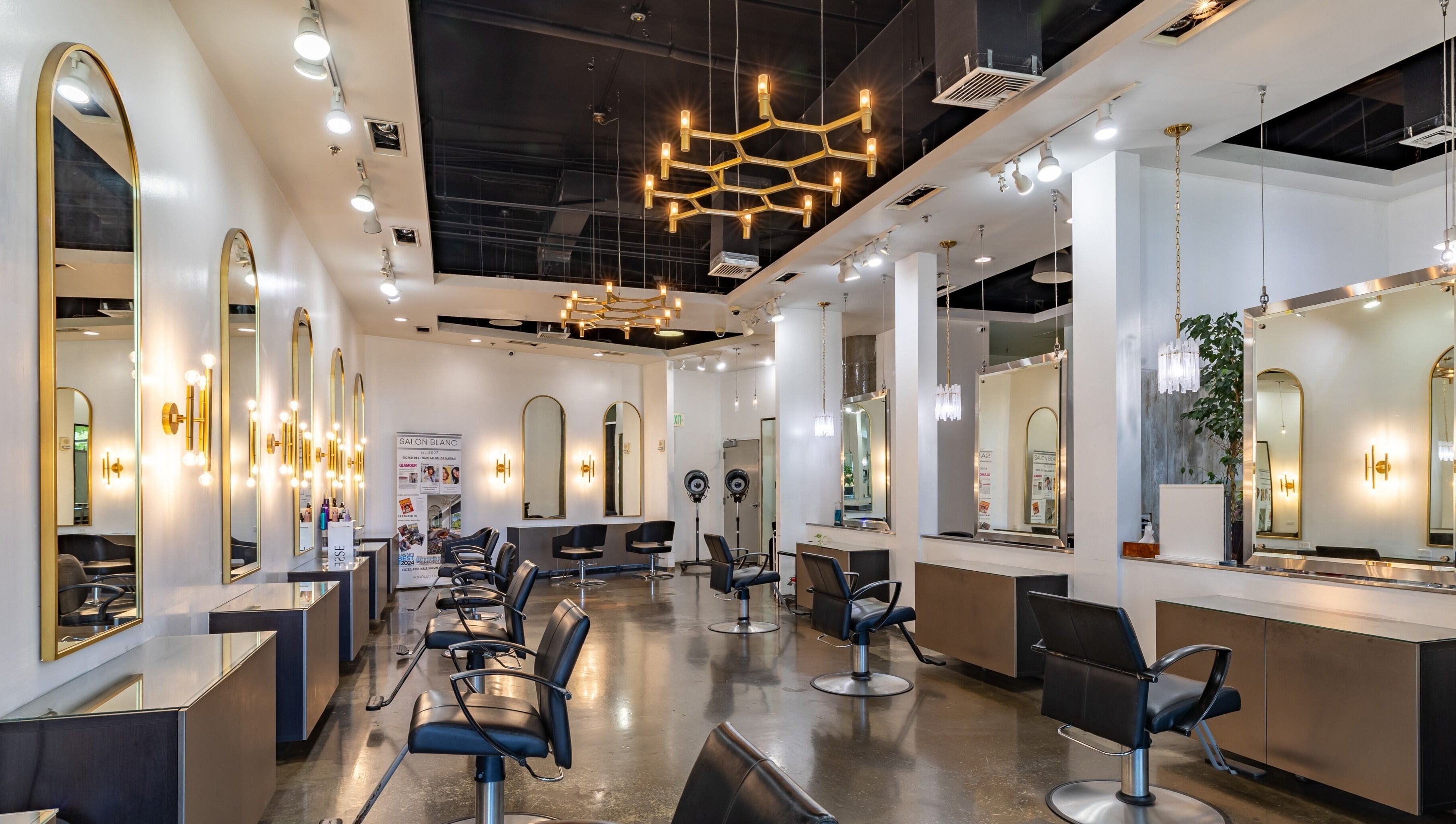 Chic interior of Salon Blanc the celebrities salon in Honolulu, Hawaii, US with stylish mirrors and lighting.