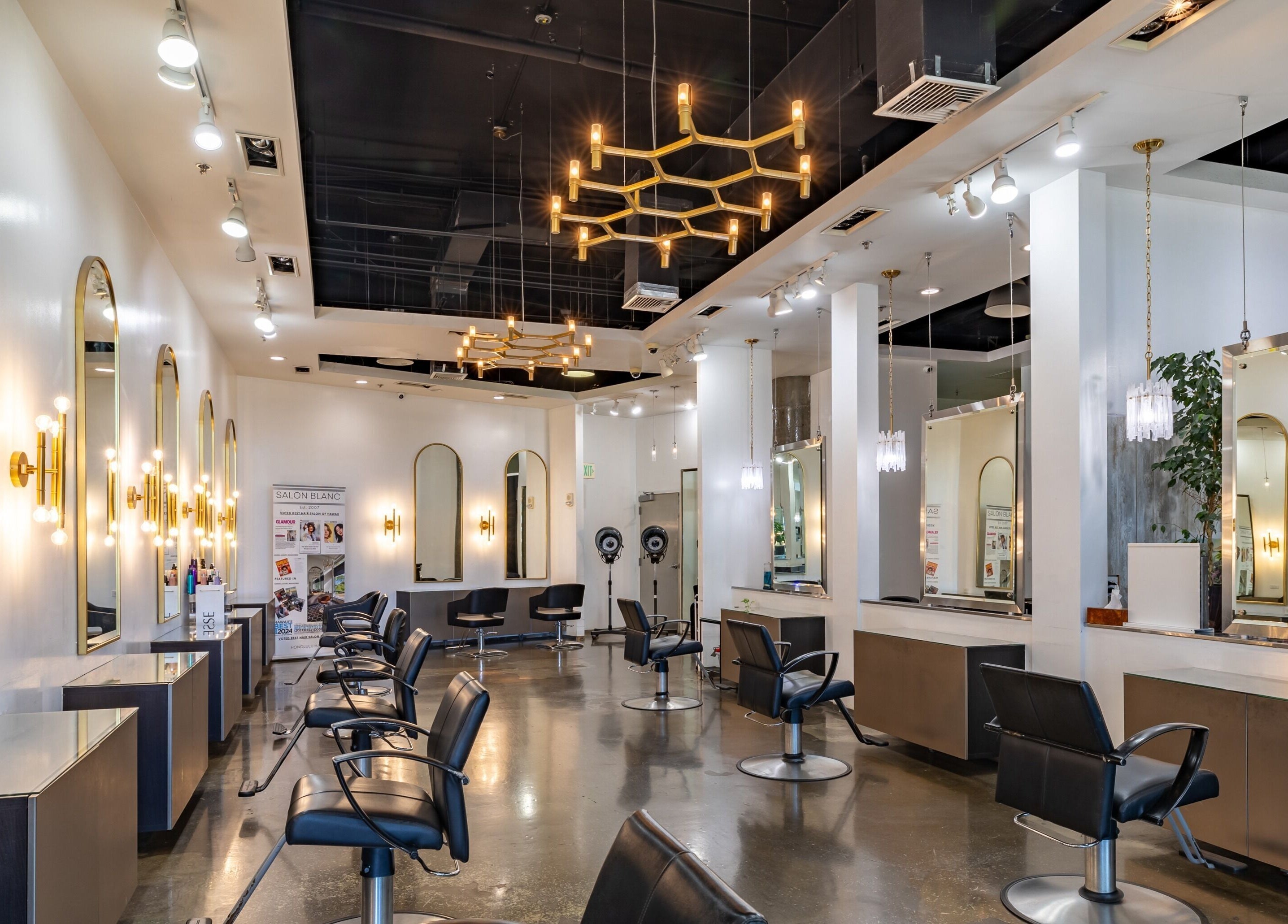 Chic interior of Salon Blanc the celebrities salon in Honolulu, Hawaii, US with stylish mirrors and lighting.